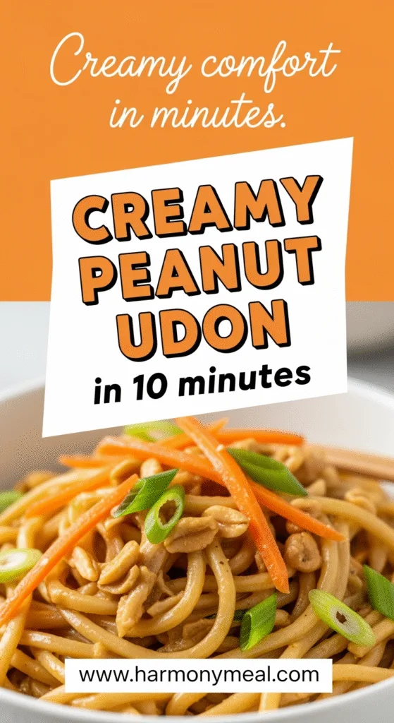 Creamy peanut udon noodles with shredded carrots and green onions close-up