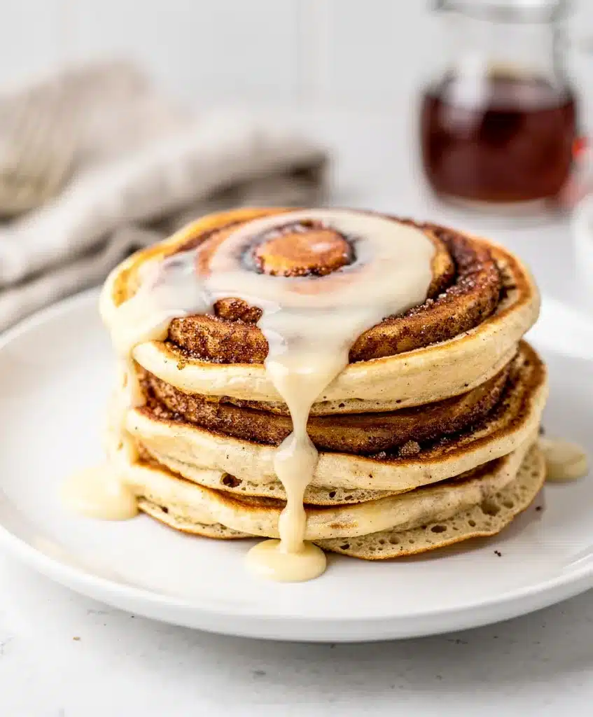 Fluffy golden pancake with cinnamon swirl and cream cheese glaze.