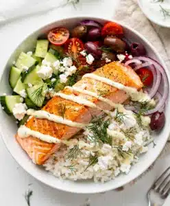 Mediterranean salmon bowls with creamy yogurt sauce and crispy seared salmon.