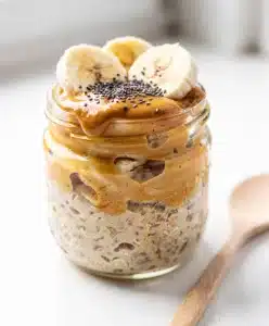 Creamy peanut butter banana overnight oats in a jar with chia seeds.