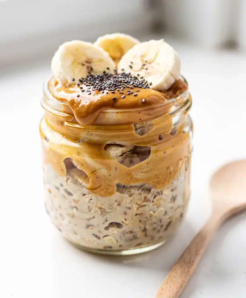 Creamy peanut butter banana overnight oats in a jar with chia seeds.