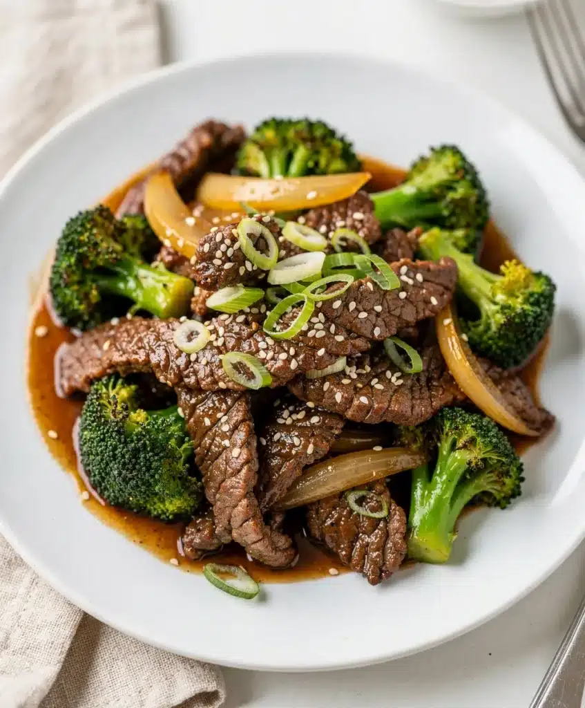 Beef and broccoli stir fry with glossy sauce and crisp green florets.