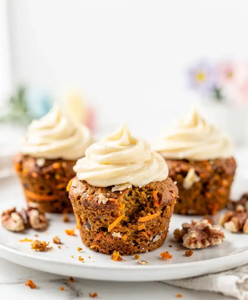 Moist carrot cake cupcakes topped with creamy cream cheese frosting.