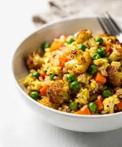 Healthy cauliflower fried rice recipe with crispy egg and colorful vegetables.