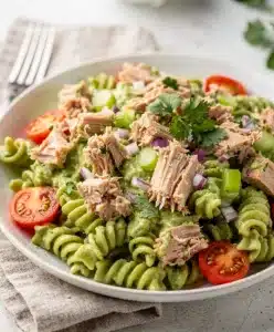 Creamy avocado tuna pasta salad recipe with rotini tomatoes and celery