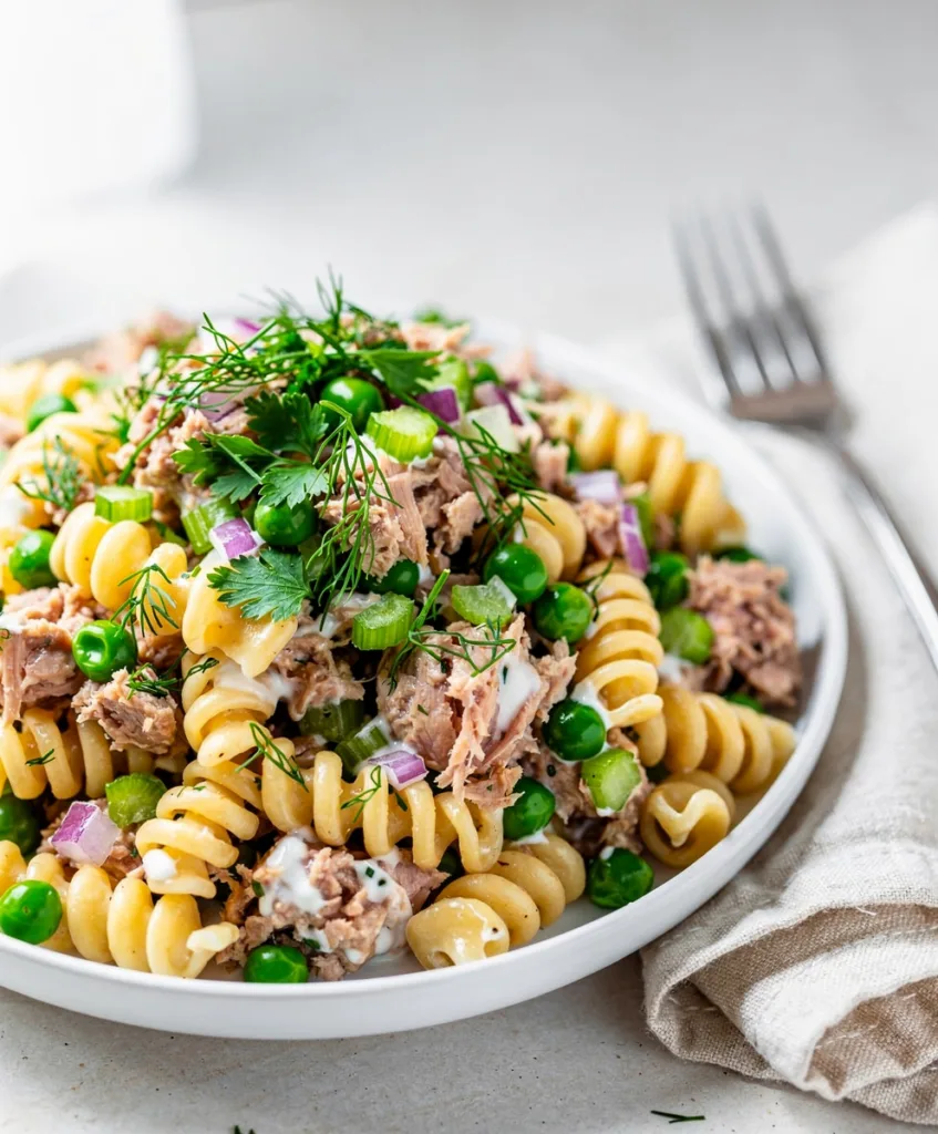 Creamy tuna pasta salad with rotini peas and a glossy dressing