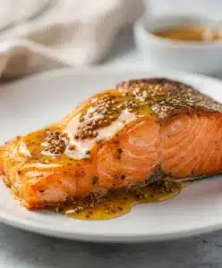 Honey mustard salmon recipe with creamy glaze in natural light closeup