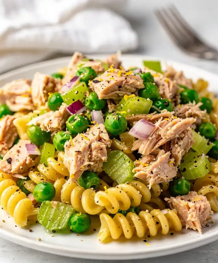 Lemon pepper tuna pasta salad with peas red onion celery and creamy dressing