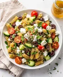 Colorful Mediterranean quinoa pasta salad with feta olives and fresh herbs
