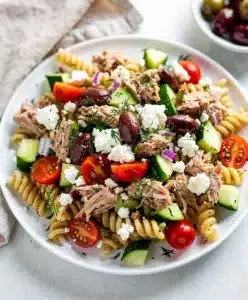 Mediterranean tuna pasta salad with fresh vegetables and lemon herb vinaigrette.