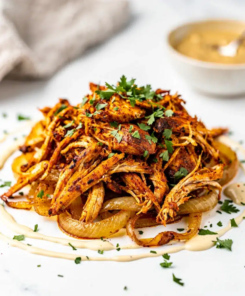 Slow cooker chicken shawarma pita wrap with tahini sauce and fresh vegetables