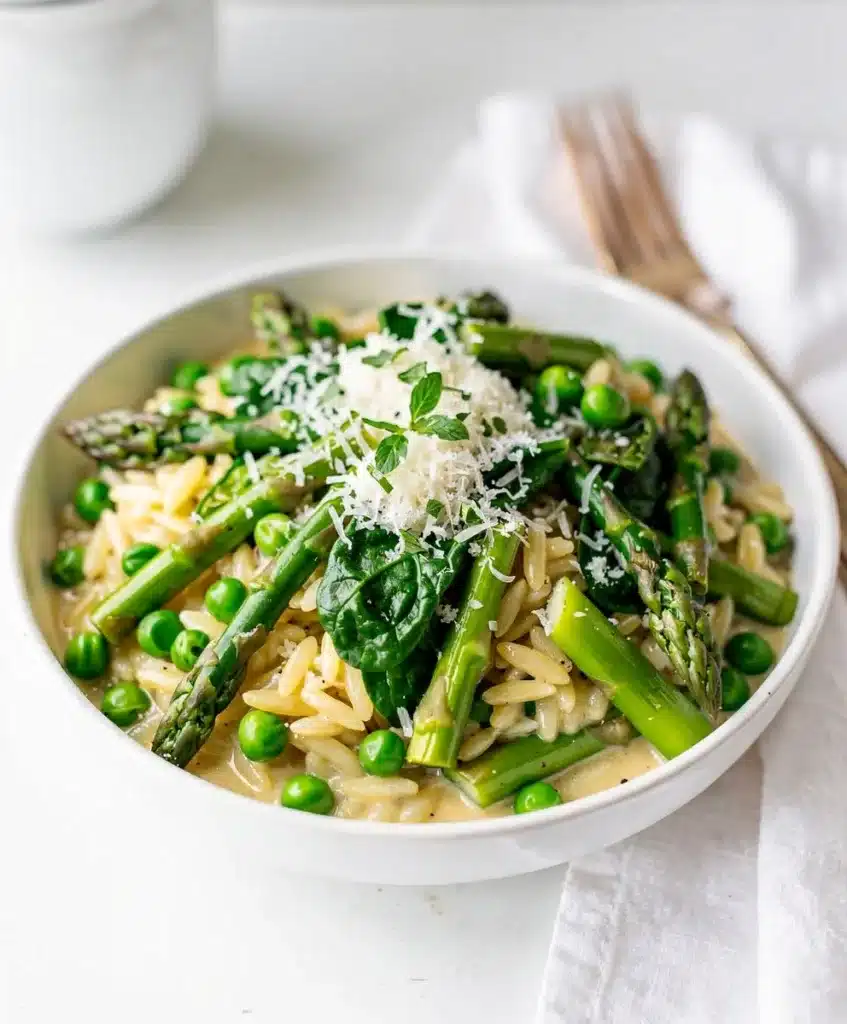Creamy spring vegetable orzo with asparagus peas dill and Parmesan cheese