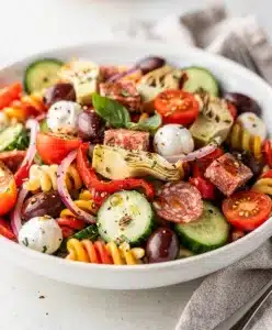 Colorful Italian antipasto salad with mozzarella pearls and crisp fresh vegetables.