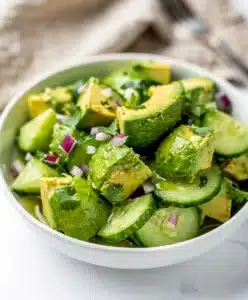 Healthy avocado cucumber salad recipe in a bright, fresh, and vibrant food photo.