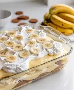 Bakery style banana pudding in a clear glass trifle bowl with creamy layers