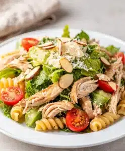Creamy chicken Caesar pasta salad with romaine lettuce and cherry tomatoes