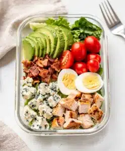 Cobb salad meal prep bowl with avocado bacon and blue cheese