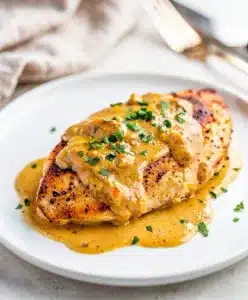 Creamy Dijon chicken recipe with golden seared breast in mustard sauce.