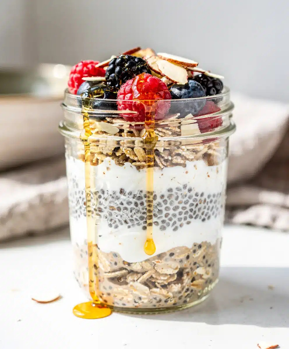 Creamy overnight oats with berries and banana in a glass jar