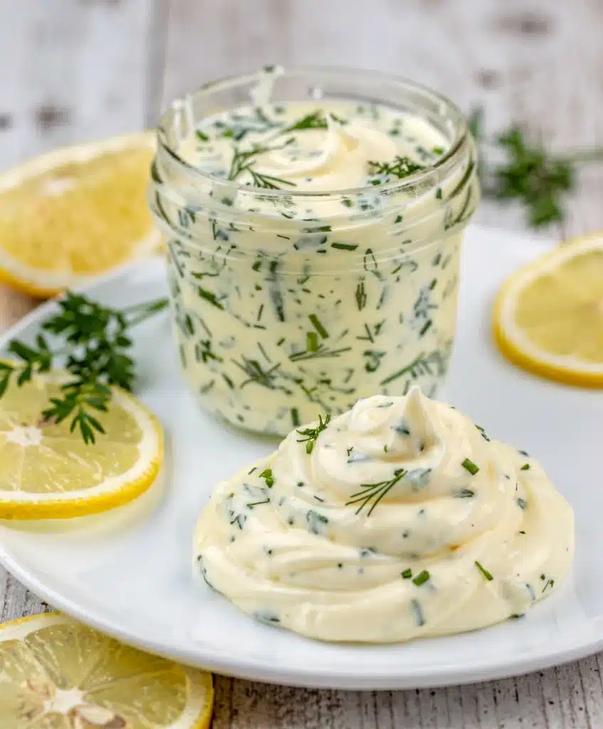 Close up overhead view of vibrant green lemon herb mayonnaise recipe in bowl