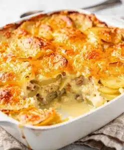 Creamy homestyle scalloped potatoes with golden cheese crust and fresh thyme