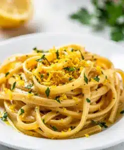 Creamy lemon garlic pasta recipe with spaghetti, fresh parsley, and parmesan cheese.