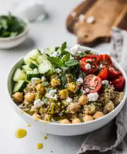 Lemon herb quinoa bowl with chickpeas cucumber tomatoes and feta cheese
