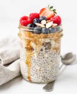 Make ahead overnight oats in a jar with fresh berries and almond slices.