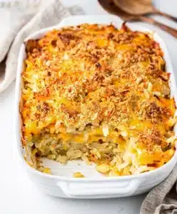 Creamy cheesy hashbrown casserole with a crispy golden cornflake topping