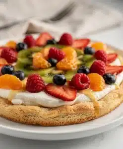 Seasonal fruit pizza sugar cookie with cream cheese frosting and fresh berries