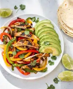 Easy sheet pan chicken fajitas with peppers and onions for a quick dinner.
