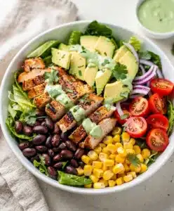 Colorful Southwest chicken salad bowl with grilled chicken and creamy avocado.