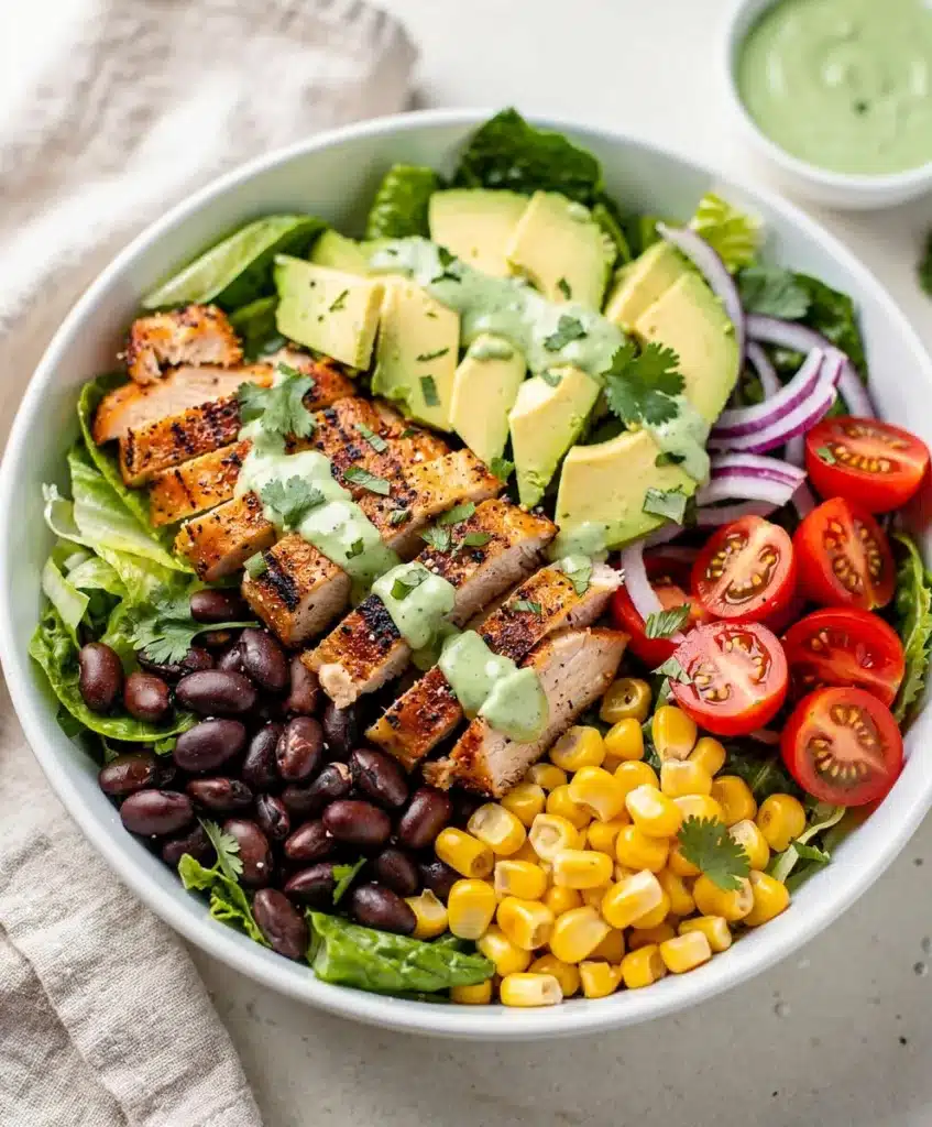 Colorful Southwest chicken salad bowl with grilled chicken and creamy avocado.