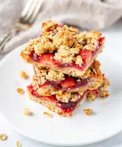 Strawberry crumble bars with a glossy filling and crispy oat topping.