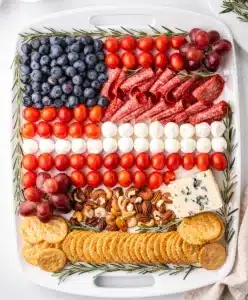 Patriotic charcuterie board with red white and blue ingredients for July Fourth.