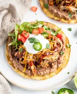 BBQ Chicken Tostadas with melted cheese and creamy beans