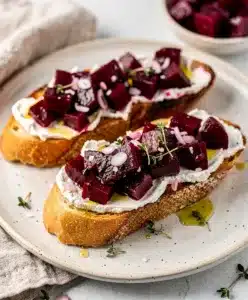 Vibrant beet goat cheese bruschetta appetizer with creamy cheese on toast