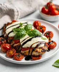 Caprese Chicken Bake with melted mozzarella and roasted tomatoes.