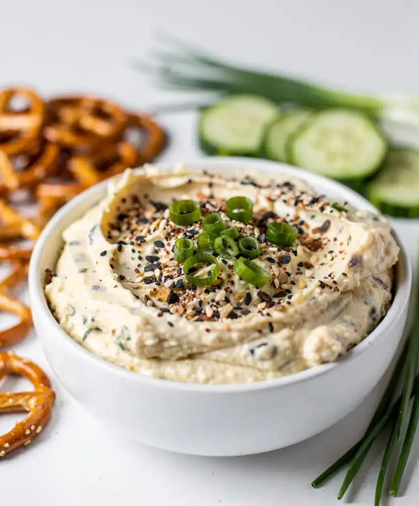 Creamy everything bagel dip with chives and seasoning for dipping vegetables