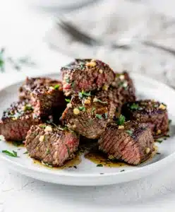 Tender garlic butter steak bites in cast iron skillet