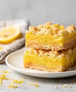 Golden brown lemon crumb bars with buttery shortbread crust