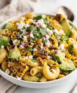 Creamy street corn pasta salad with cotija and avocado.