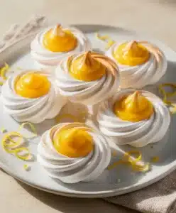 Mini Meringues with glossy lemon curd close up vibrant food photo
