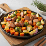 Chicken apple sausage sheet pan dinner with roasted vegetables.