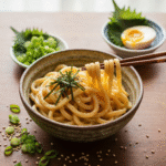 Creamy miso udon noodles with scallions and soft-boiled egg.