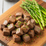 High Protein Slow Cooker Garlic Butter Beef Bites with asparagus