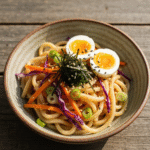Cold Japanese yaki udon noodle salad with egg and vegetables.