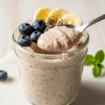 Creamy blended overnight oats in a jar with fruit and chia seeds.