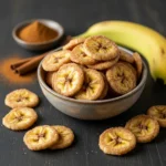 Crispy cinnamon sugar banana chips in a rustic ceramic bowl.