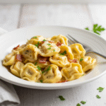 Creamy tortellini carbonara with bacon and Parmesan cheese.